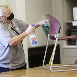 Stephanie Harrill, Skyline High School custodian, cleans chairs to get ready for the start of school at Skyline High School in Millcreek on Thursday, July 23, 2020.