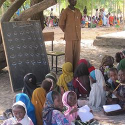 Students go to school at an outdoor classroom in Goz Amer refugee camp.