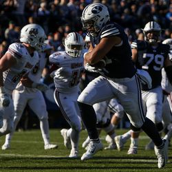 Brigham Young Cougars linebacker Harvey Langi (21) runs for a touchdown, putting BYU up 27-9 after the PAT, during a game against the UMass Minutemen at LaVell Edwards Stadium in Provo on Saturday, Nov. 19, 2016.