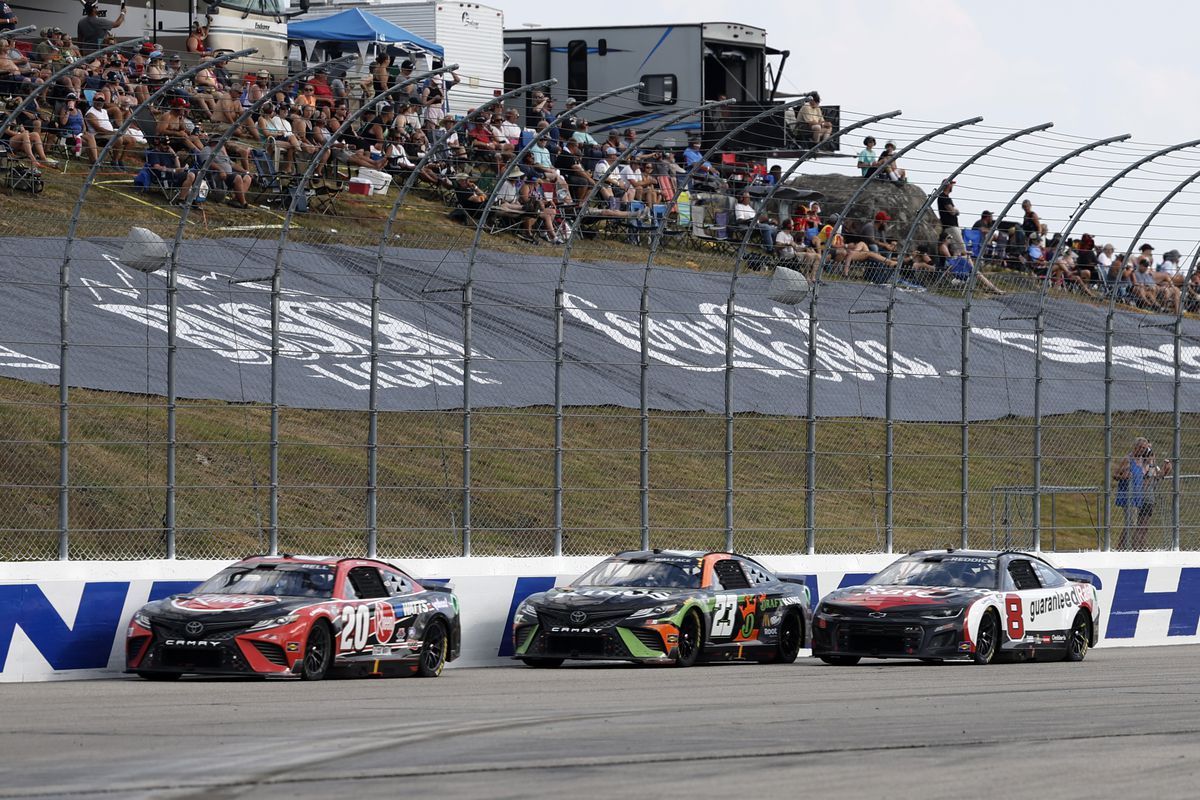 Christopher Bell (#20 Joe Gibbs Racing Rheem/WATTS Toyota) leads Bubba Wallace (#23 23XI Racing Draft Kings Toyota) on the back straight during the NASCAR Cup Series Ambetter 301 on July 17, 2022, at New Hampshire Motor Speedway in Loudon. New Hampshire.