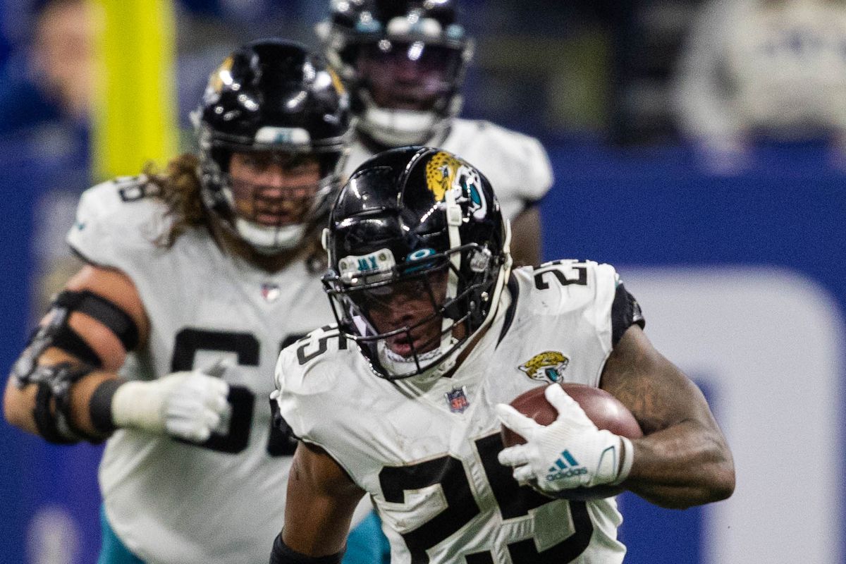 Jacksonville Jaguars running back James Robinson (25) runs the ball while Indianapolis Colts middle linebacker Bobby Okereke (58) defends in the second half at Lucas Oil Stadium.