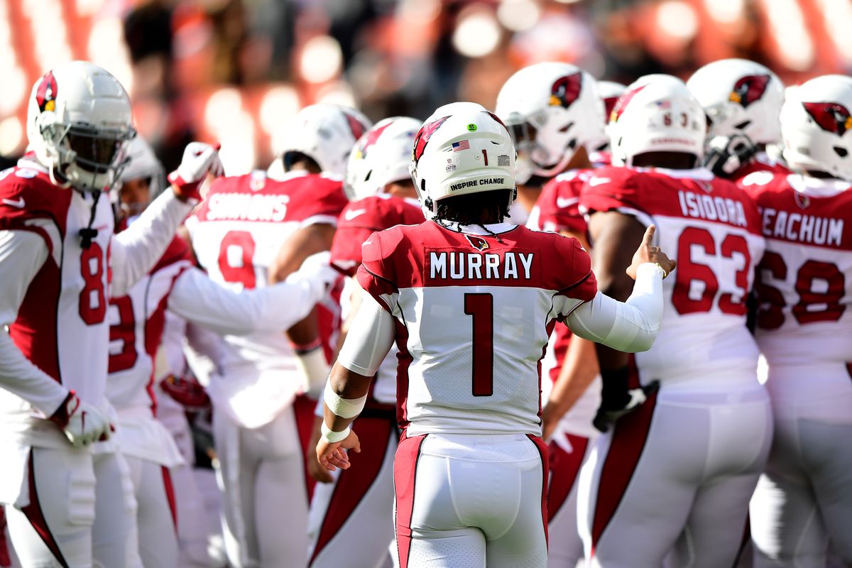 Kyler Murray #1 of the Arizona Cardinals huddles with teammates during warmups before a game against the Cleveland Browns at FirstEnergy Stadium on October 17, 2021 in Cleveland, Ohio.