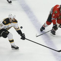 Boston Bruins right wing Nathan Horton (18) brings the puck up the ice against Chicago Blackhawks defenseman Brent Seabrook (7) in the first period during Game 5 of the NHL hockey Stanley Cup Finals, Saturday, June 22, 2013, in Chicago. (AP Photo/Nam Y. Huh)