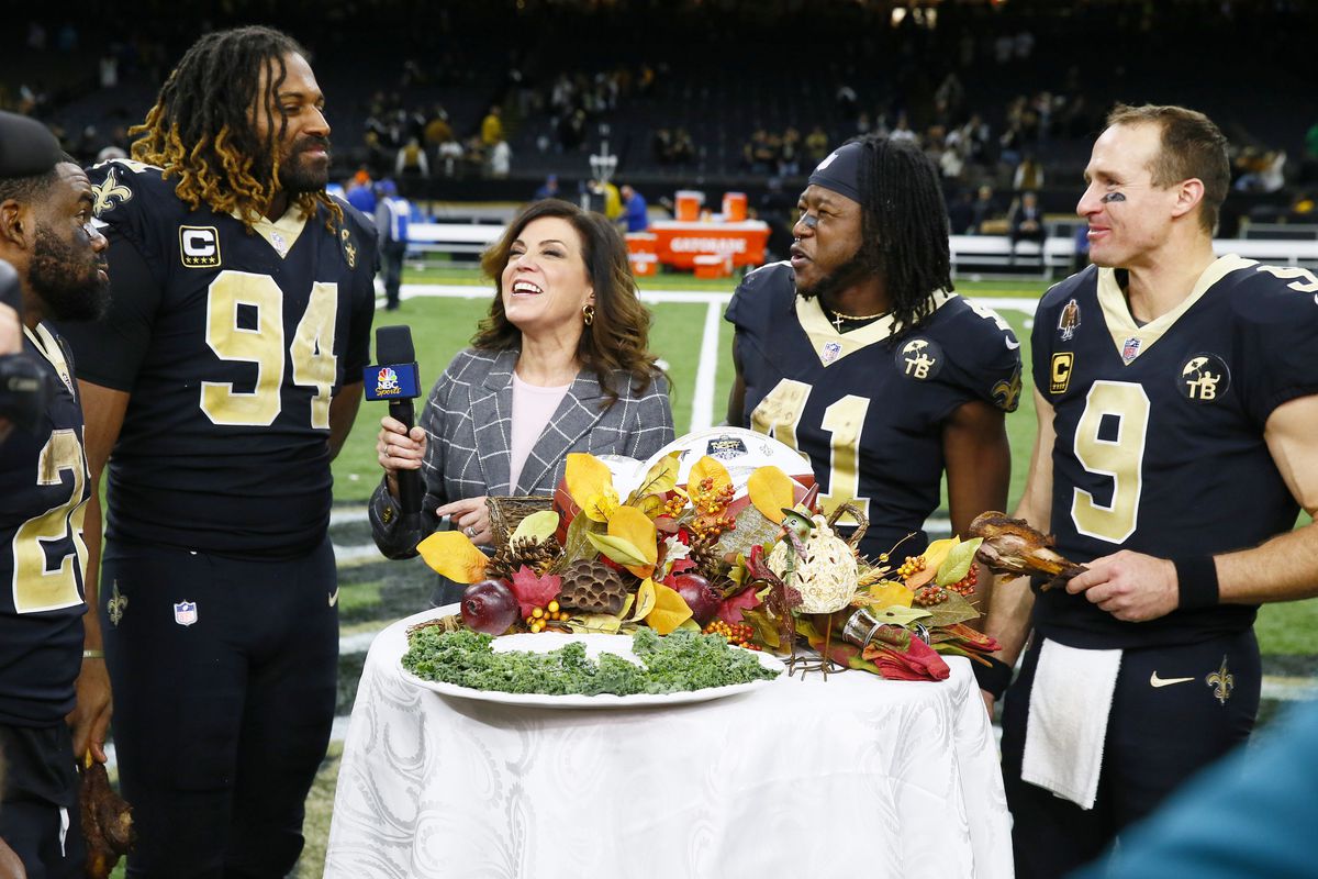 New Orleans Saints Cameron Jordan (94) during on field interview with NBC Sports Michelle Tofoya after game vs Atlanta Falcons at Mercedes-Benz Superdome. QB Drew Brees holding turkey drumstick with Alvin Kamara (41) looking on.