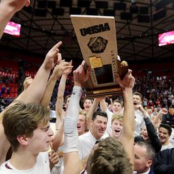 Lone Peak celebrates its win over Pleasant Grove for the 6A basketball championship in the Jon M. Huntsman Center at the University of Utah on Saturday, March 3, 2018.