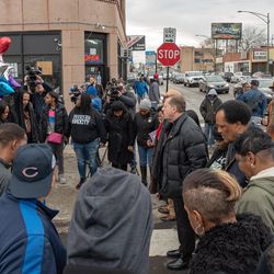 St. Sabina Pastor Michael Pfleger leads a group in prayer at the scene where Dareyona Smith was killed a day earlier. | Nader Issa/Sun-Times