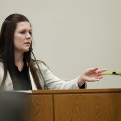 Alexis Somers is handed documents by Chad Grunander, Utah County prosecutor, while testifying at the trial of her father, Martin MacNeill, at 4th District Court in Provo Wednesday, Oct. 30, 2013. MacNeill is charged with murder for allegedly killing his wife, Michele MacNeill, in 2007.