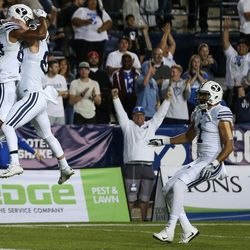 Brigham Young Cougars wide receiver Jonah Trinnaman (84) and wide receiver Mitchell Juergens (87) celebrate after Trinnaman run in for a touchdown during a game at LaVell Edwards Stadium in Provo on Friday, Sept. 30, 2016.