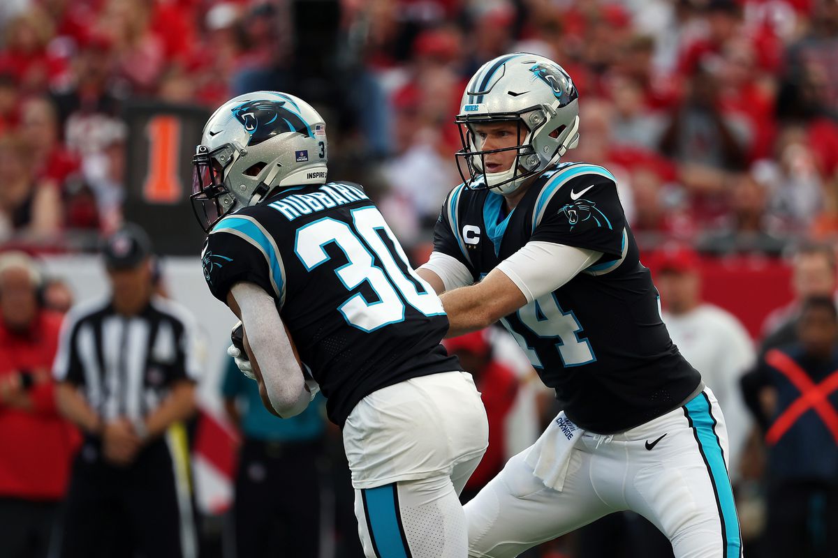 Sam Darnold #14 of the Carolina Panthers hands the ball off to Chuba Hubbard #30 of the Carolina Panthers during the first quarter at Raymond James Stadium on January 09, 2022 in Tampa, Florida.