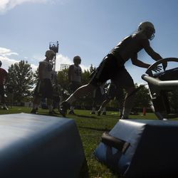 Linebacker Troy Hinds practices a drill during BYU football camp at SAB outdoor practice field, Friday, Aug. 1, 2014. 