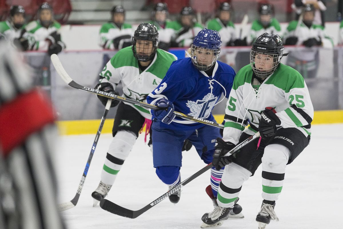 Hayley Williams, wearing Furies home blue uniform skates between Taylor Woods (in front) and Jamie Lee Rattray (coming up from behind), both wearing Thunder road whites with green accents.&nbsp;