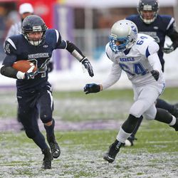 Duchesne's Dylan Despain runs past Rich's Issac Hopkin as Duchesne High School and Rich High School play in the 1A State football championship game  Saturday, Nov. 16, 2013, in Ogden.  