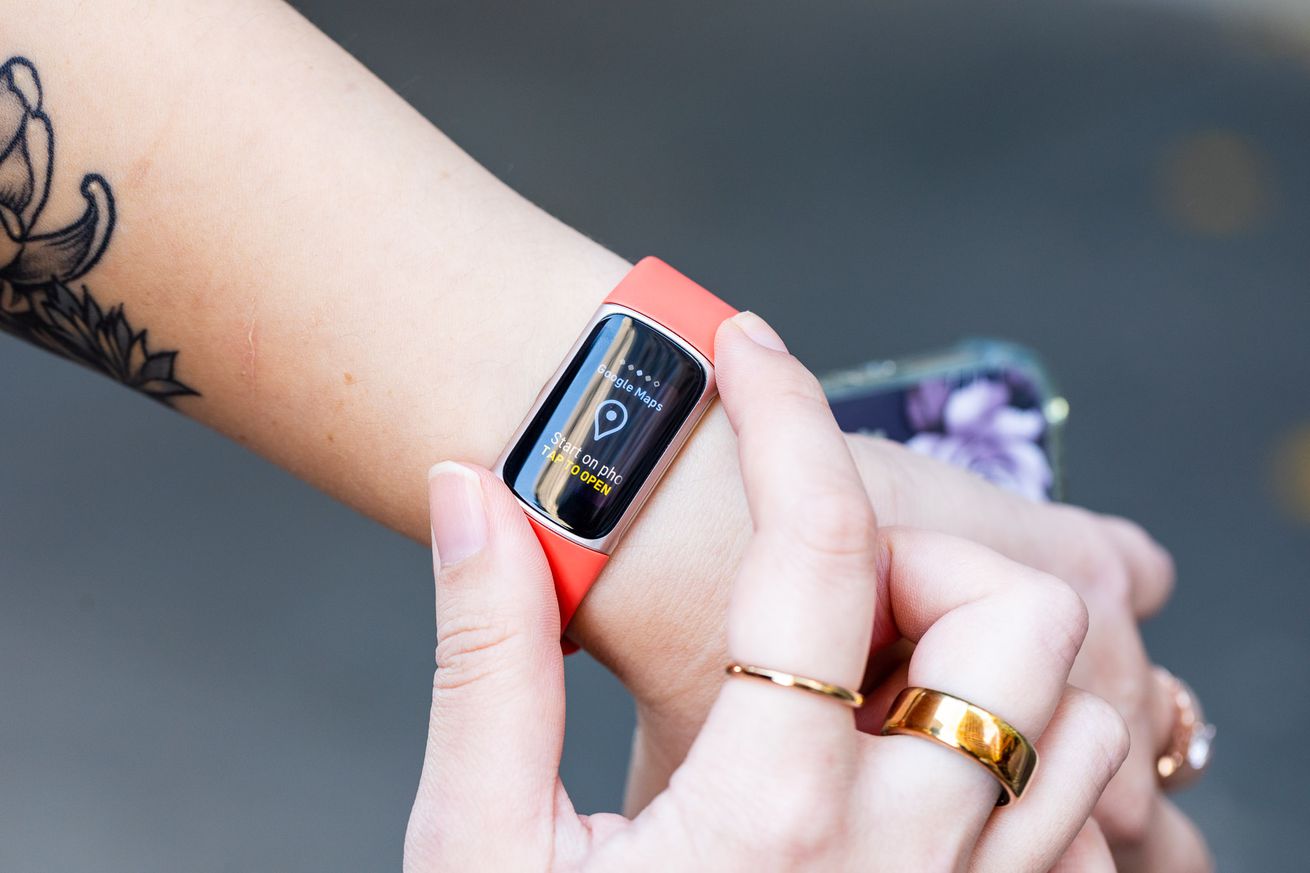 Person looking at Google Maps screen on Fitbit Charge 6