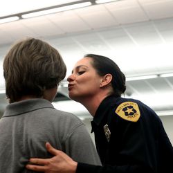 Officer Sarah Crane kisses her son during a Salt Lake City Police Department Academy graduation ceremony at the Pioneer Precinct in Salt Lake City on Friday, March 4, 2016. Fifteen Salt Lake police and two fire department recruits spent 23 weeks training in the police academy. Beginning Monday, the new officers will embark on 15 weeks of field training with veteran officers in order to be certified for solo patrol work. 