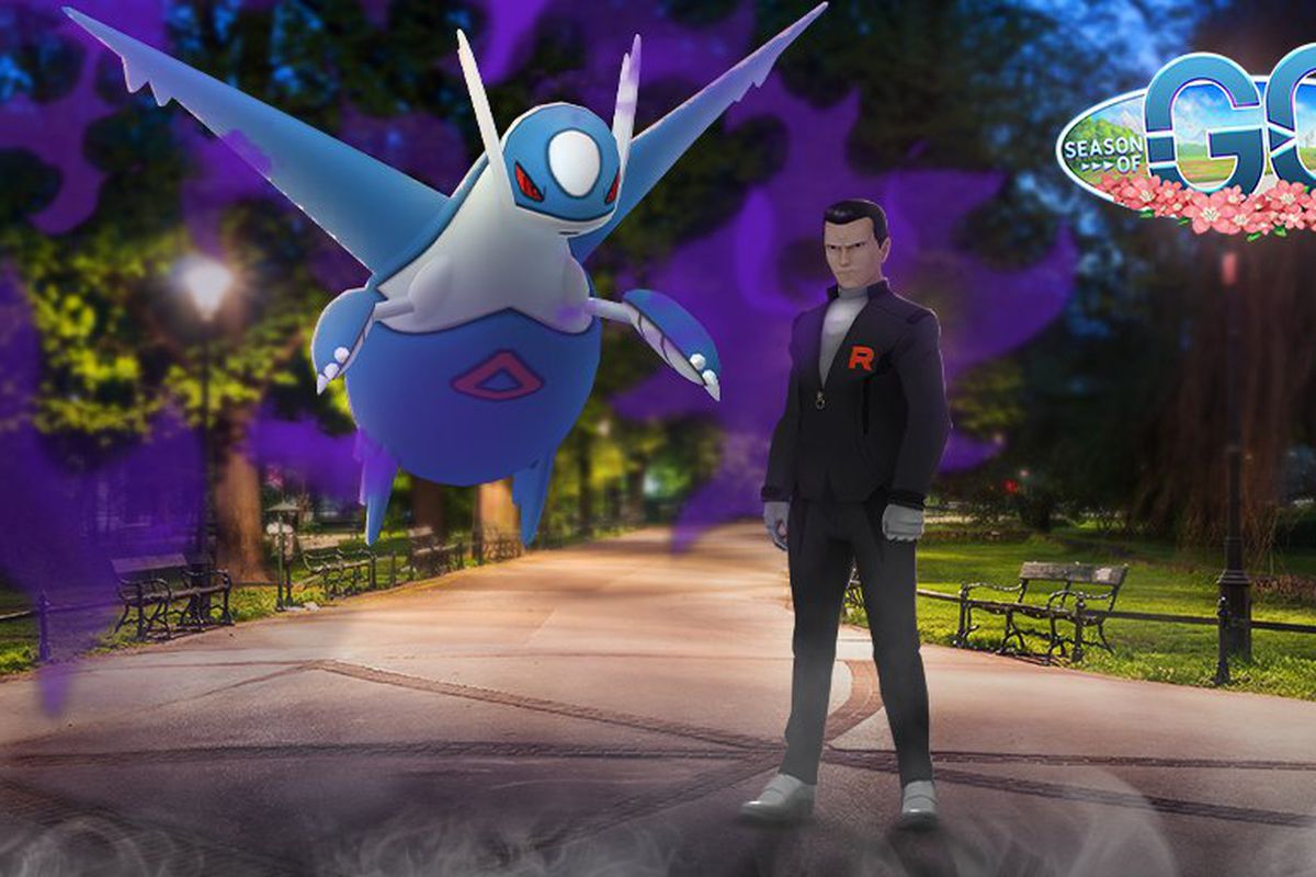 Giovanni stands in a park with a Shadow Latios