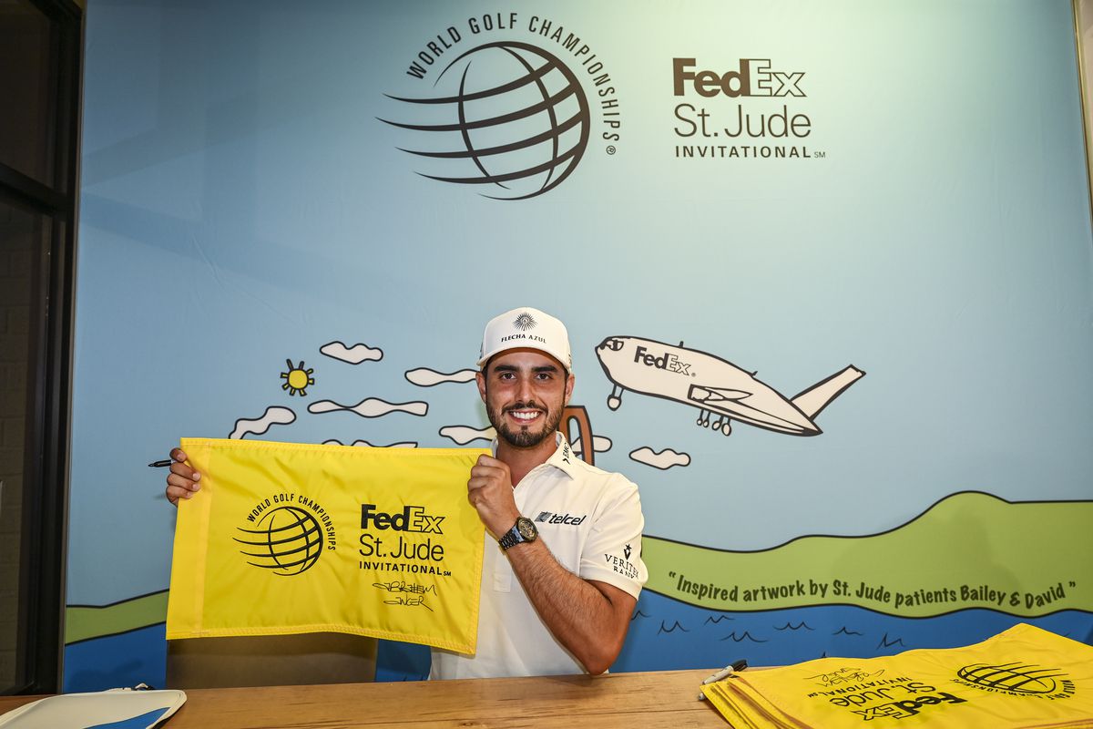 Abraham Ancer of Mexico poses with a signed pin flag following his playoff victory in the final round of the World Golf Championships-FedEx St. Jude Invitational at TPC Southwind on August 8, 2021 in Memphis, Tennessee.