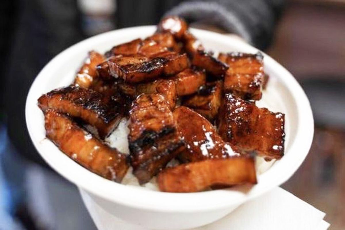 A plate of grilled pork belly sinugba served over jasmine rice.