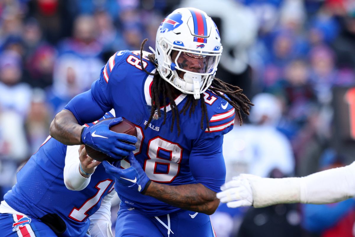 ORCHARD PARK, NEW YORK - JANUARY 15: James Cook #28 of the Buffalo Bills carries the ball against the Miami Dolphins during the first half in the AFC Wild Card playoff game at Highmark Stadium on January 15, 2023 in Orchard Park, New York.