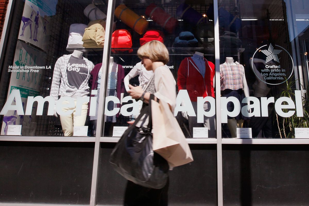 woman walks in front of an american apparel