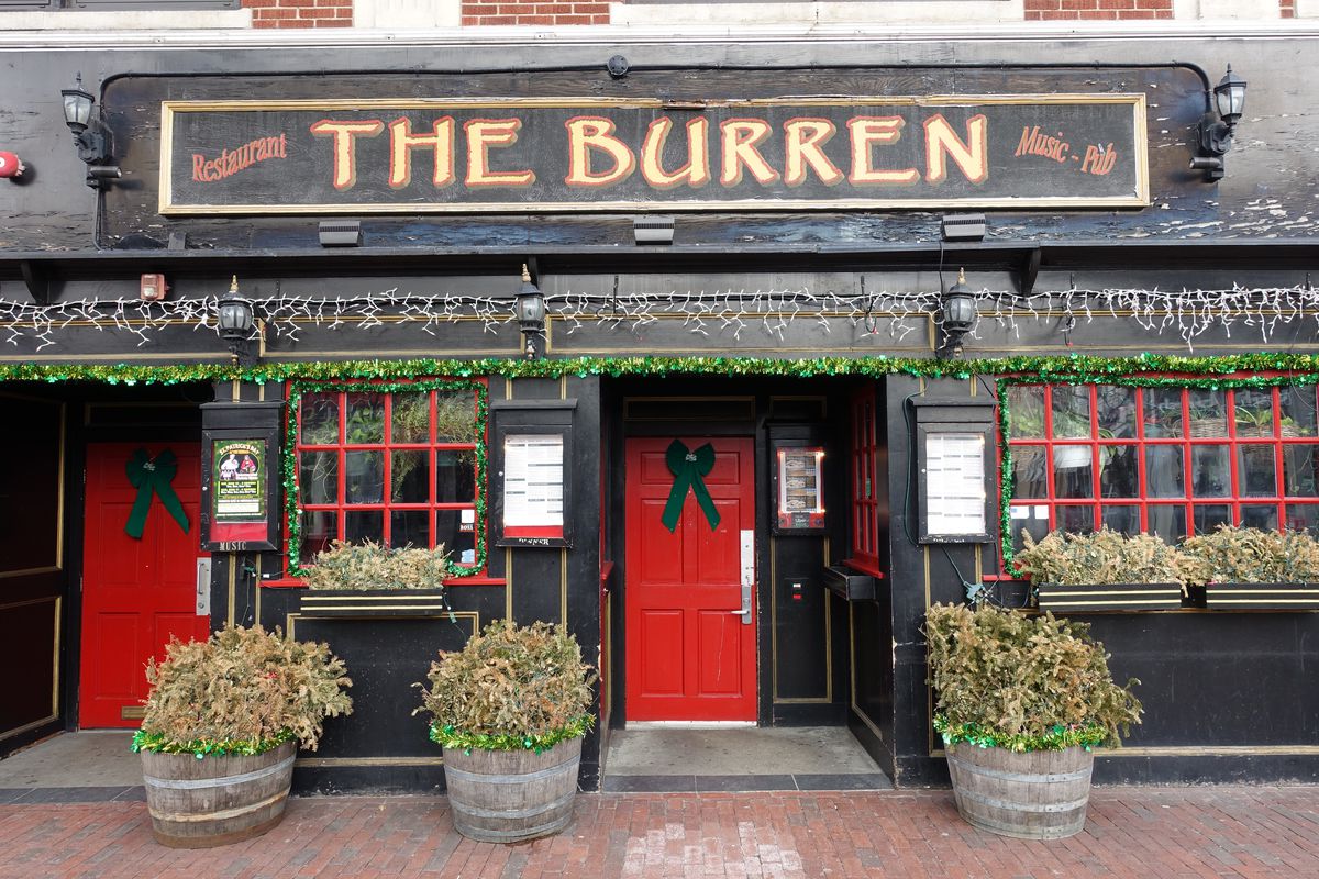 The exterior of the Burren in Somerville’s Davis Square, painted black with bright red doors and window frames