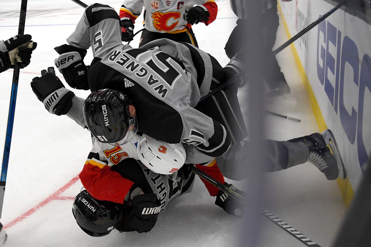 Los Angeles Kings defenseman Drew Doughty (8) is taken down by Calgary Flames center Tobias Rieder (16) as Los Angeles left wing Austin Wagner (51) jumps on the pile in the third period at Staples Center
