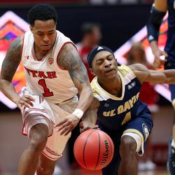 Utah Utes guard Justin Bibbins (1) has the ball knocked away by UC Davis Aggies guard Arell Hennings (4) in the final moments as Utah and UC Davis play in an NIT basketball game at the Huntsman Center in Salt Lake City on Wednesday, March 14, 2018. Utah won 69-59.