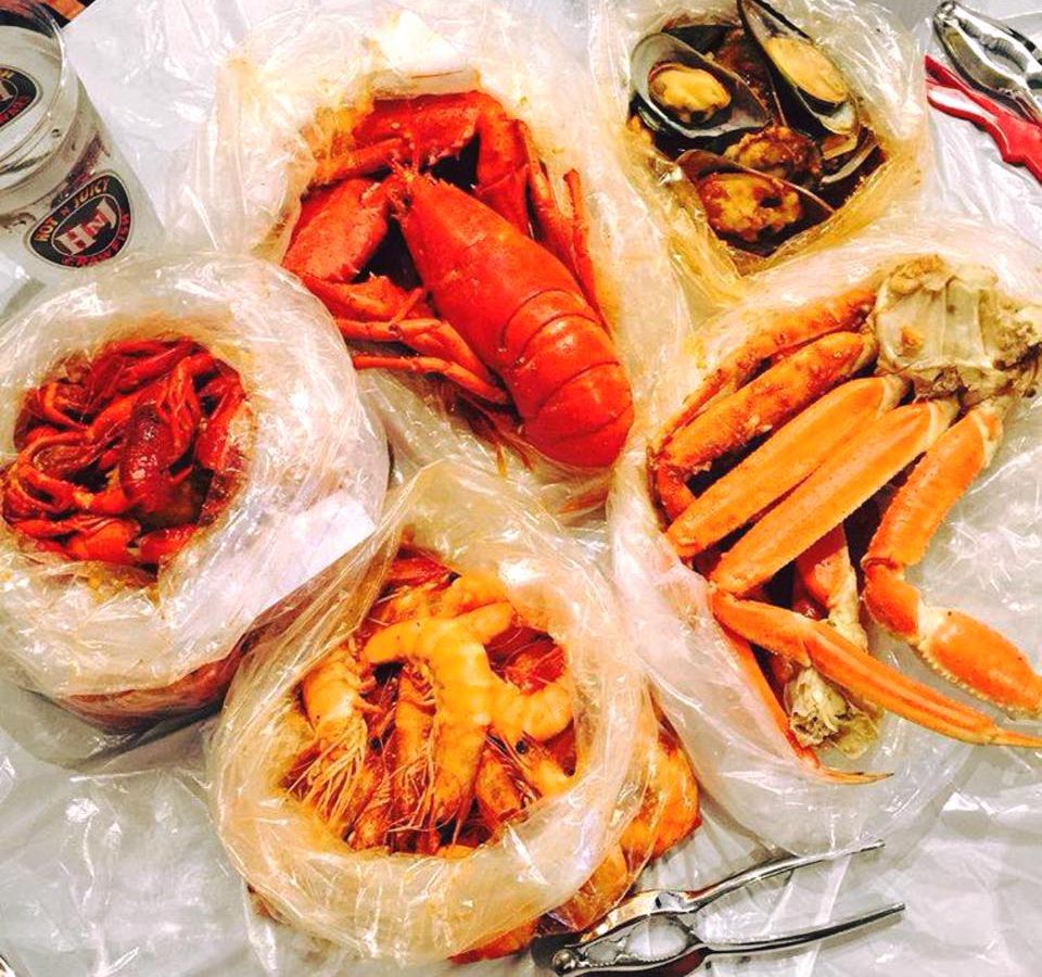 Bags with lobster, shrimp, crab legs, crawfish, and more.