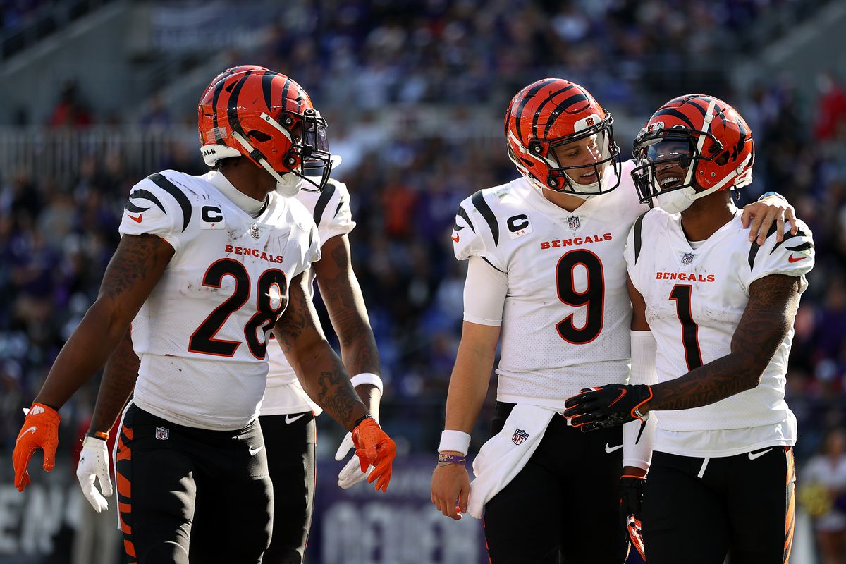 Joe Mixon #28 and Joe Burrow #9 celebrate with wide receiver Ja’Marr Chase #1 of the Cincinnati Bengals after Chase scored a second half touchdown against the Baltimore Ravens at M&amp;T Bank Stadium on October 24, 2021 in Baltimore, Maryland.