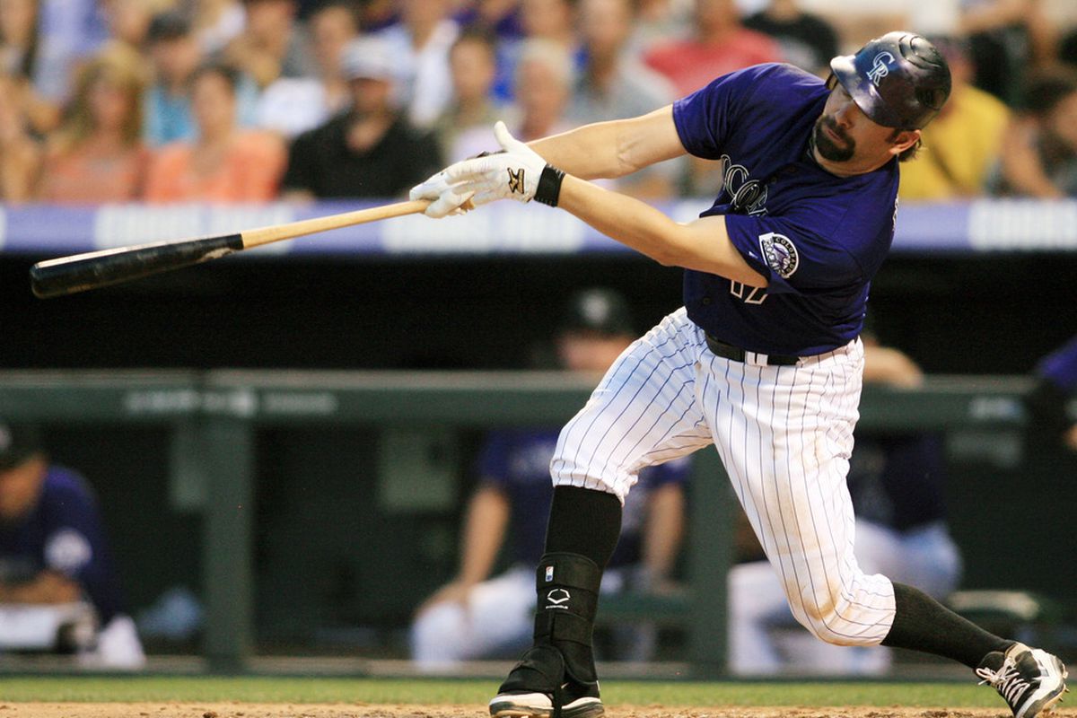 June 25, 2012; Denver, CO, USA; Colorado Rockies first baseman Todd Helton hits (17) a sacrifice RBI during  the sixth inning against the Washington Nationals  at Coors Field.  Mandatory Credit: Chris Humphreys-US PRESSWIRE