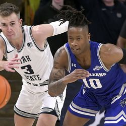 Utah State guard Steven Ashworth (3) and New Orleans guard Derek St. Hilaire (10) watch the ball during the second half of an NCAA college basketball game Saturday, Dec. 11, 2021, in Logan, Utah.