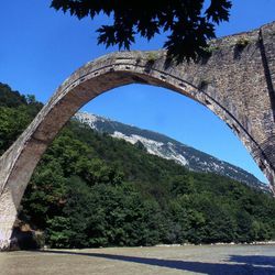 In this June, 2002 file photo, the 18th-century Plaka bridge which spans the Arachthos river in the village of Plaka Raftanaion in the Epirus region, northwestern Greece. The bridge was destroyed by flooding on Sunday, Feb. 1, 2015 as flash floods caused by heavy rains submerged large areas in northwestern Greece, forcing authorities to evacuate several villages in the Epirus region.