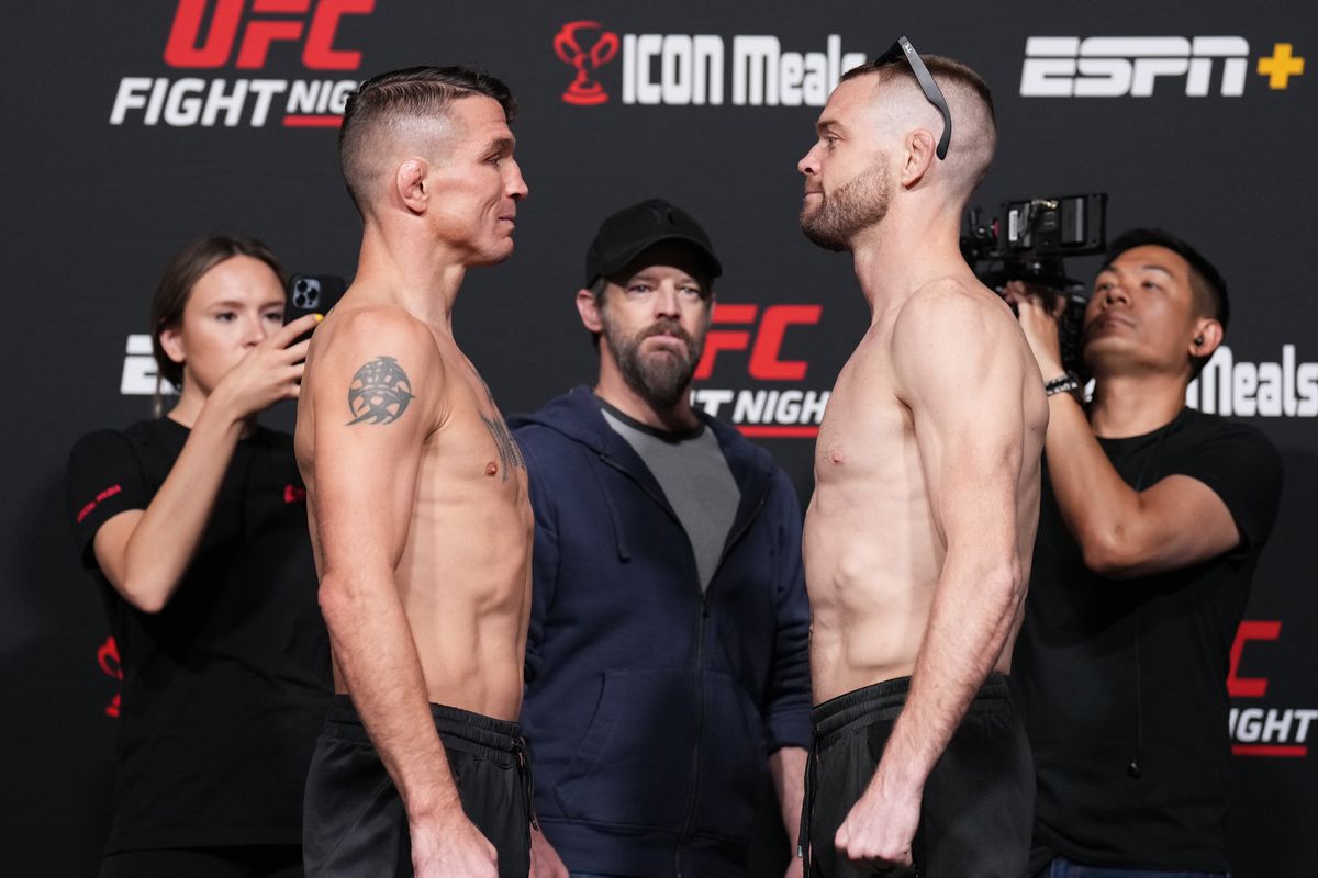 Opponents Darren Elkins and Tristan Connelly of Canada face off during the UFC weigh-in at UFC APEX on April 29, 2022 in Las Vegas, Nevada.