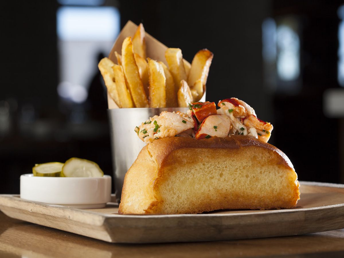 A lobster roll with fries
