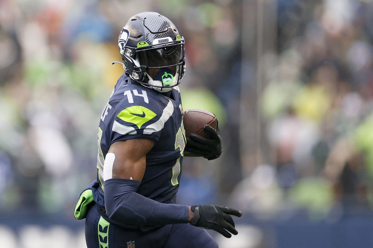 SEATTLE, WASHINGTON - JANUARY 02: DK Metcalf #14 of the Seattle Seahawks carries the ball against the Detroit Lions during the first half at Lumen Field on January 02, 2022 in Seattle, Washington.