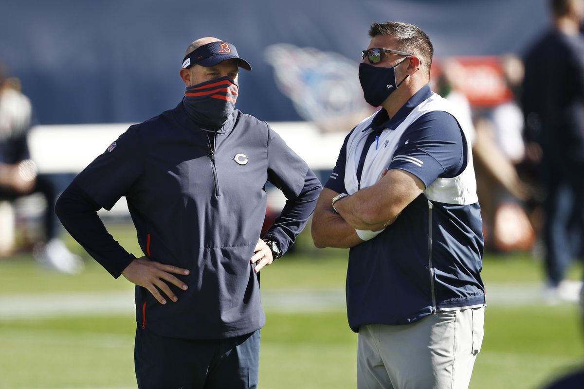 Masked up: Bears coach Matt Nagy (left) and Titans coach Mike Vrabel (right) chat before Sunday’s game. 