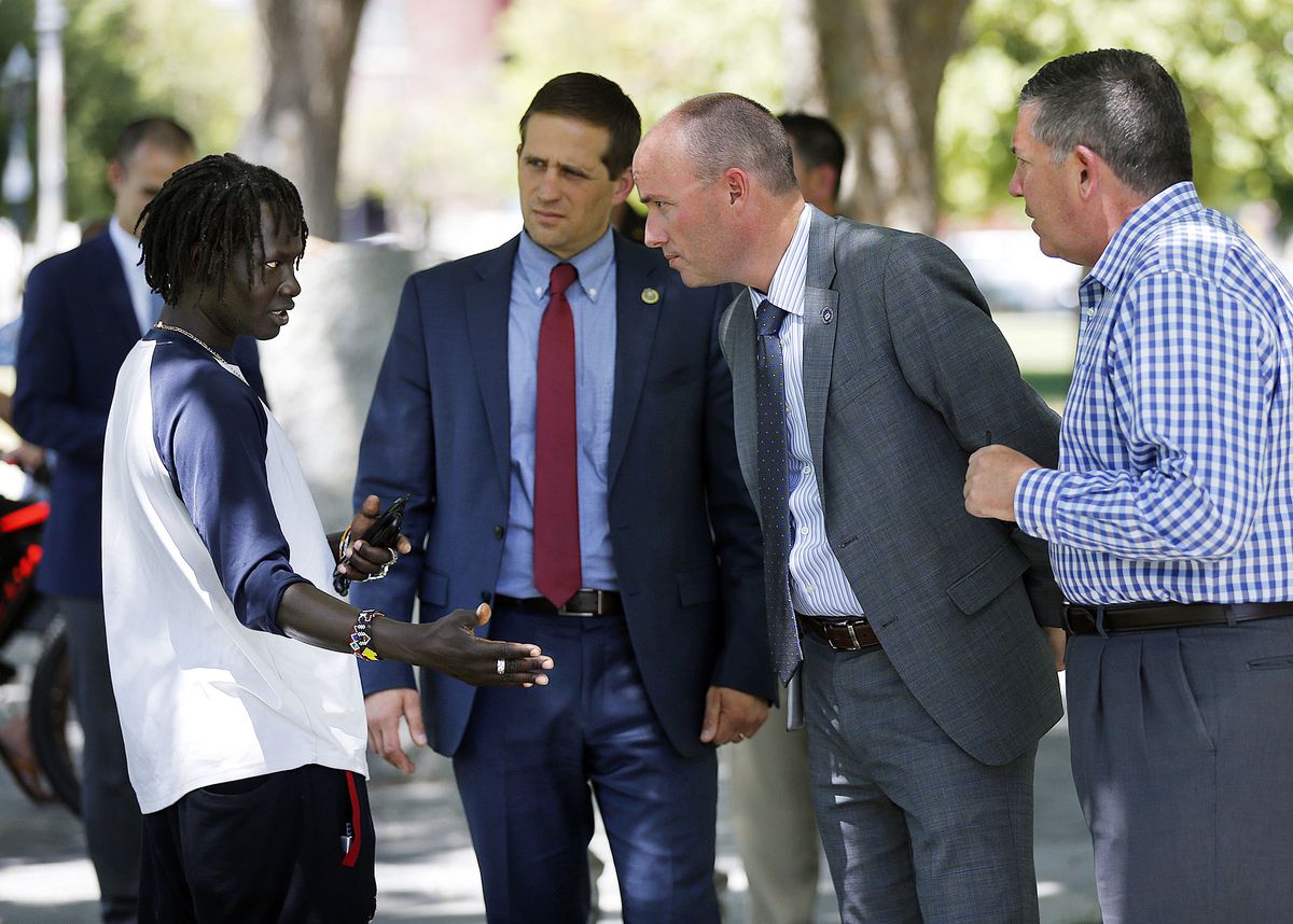 Lt. Gov. Spencer Cox, second from right, talks with Isaac Ahmed Tirko, who is homeless, during a tour of Pioneer Park in the Rio Grande area of Salt Lake City on Monday, June 25, 2018.