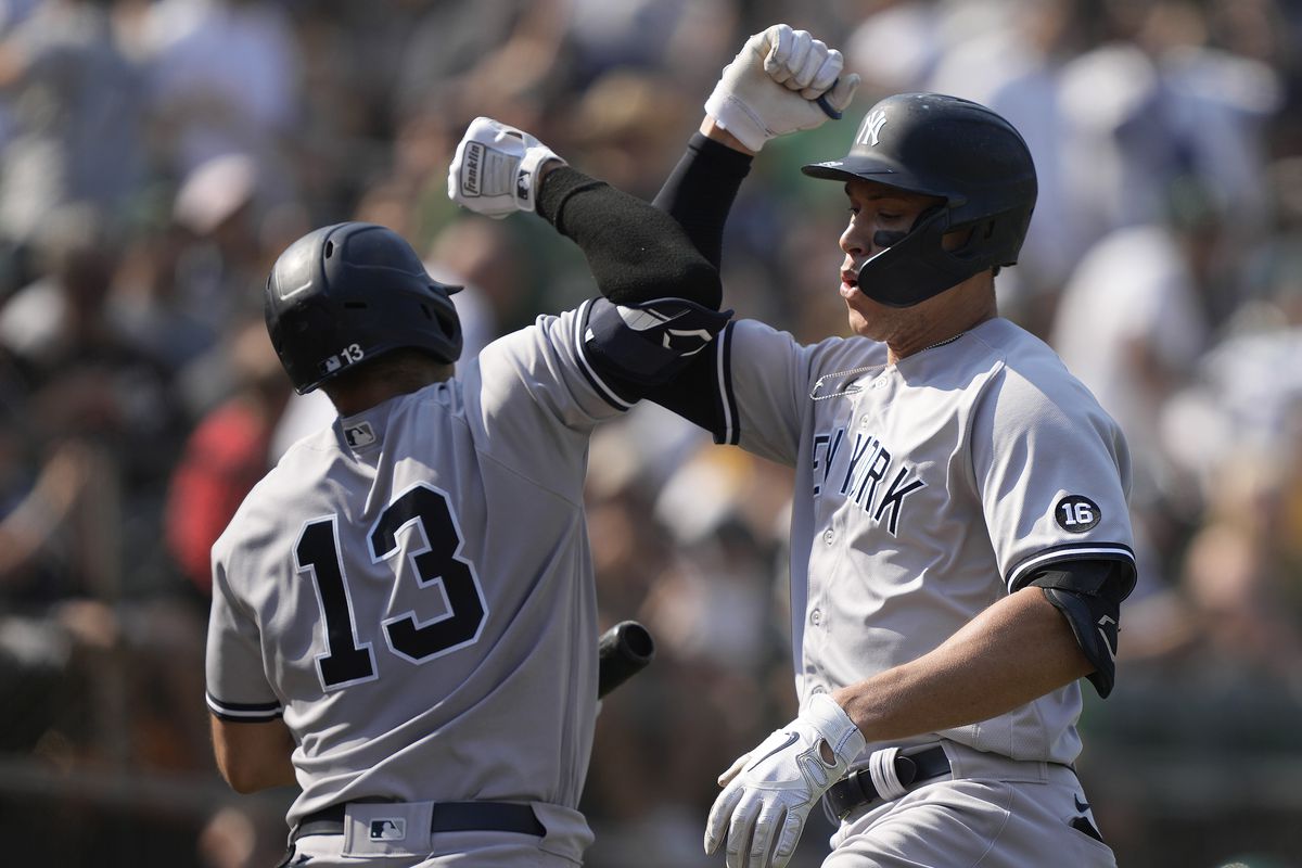 Aaron Judge and Joey Gallo of the New York Yankees celebrates after Judge hit a two-run home run against the Oakland Athletics in the top of the ninth inning at RingCentral Coliseum on August 28, 2021 in Oakland, California.