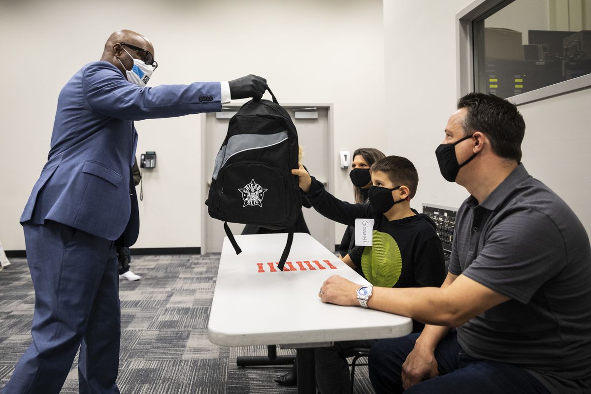 Chicago Police Supt. David Brown gives 10-year-old Giovanni Alonzo a backpack for donating plastic strips designed to lessen irritation brought on by face masks to the department, during a press conference at CPD headquarters, Wednesday afternoon, April 29, 2020.