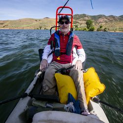 Derek Sunquist controls a sailboat with blows and sucks through a straw at East Canyon Reservoir in East Canyon State Park on Thursday, July 18, 2019. The Tetradapt Initiative offers a variety of adaptive recreation options including a sailboat that allows quadriplegics to sail.