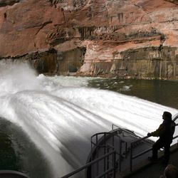 In a Wednesday, March 5, 2008 file photo, water flows from the number one and two jet tubes at the Glen Canyon Dam in Page, Ariz. to mimic natural flooding. A man-made flood sent torrents of water from Glen Canyon Dam on the Arizona-Utah line for 60 hours in 2008 in an effort to build up sandbars crucial for wildlife. The experiment, meant to mimic natural flooding in the Colorado River through the Grand Canyon proved beneficial, but scientists say the gains were short-lived.