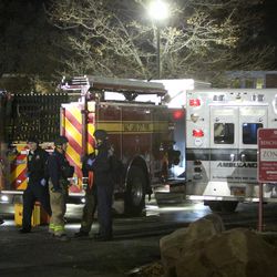 Fire trucks and ambulances wait at the staging area on Connor Street during the search for the suspect in a fatal shooting near the University of Utah in Salt Lake on Monday, Oct. 30, 2017.
