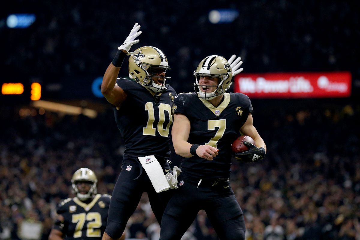 Taysom Hill #7 of the New Orleans Saints celebrates with Tre’Quan Smith #10 after scoring a touchdown against the Los Angeles Rams during the third quarter in the NFC Championship game at the Mercedes-Benz Superdome on January 20, 2019 in New Orleans, Louisiana.