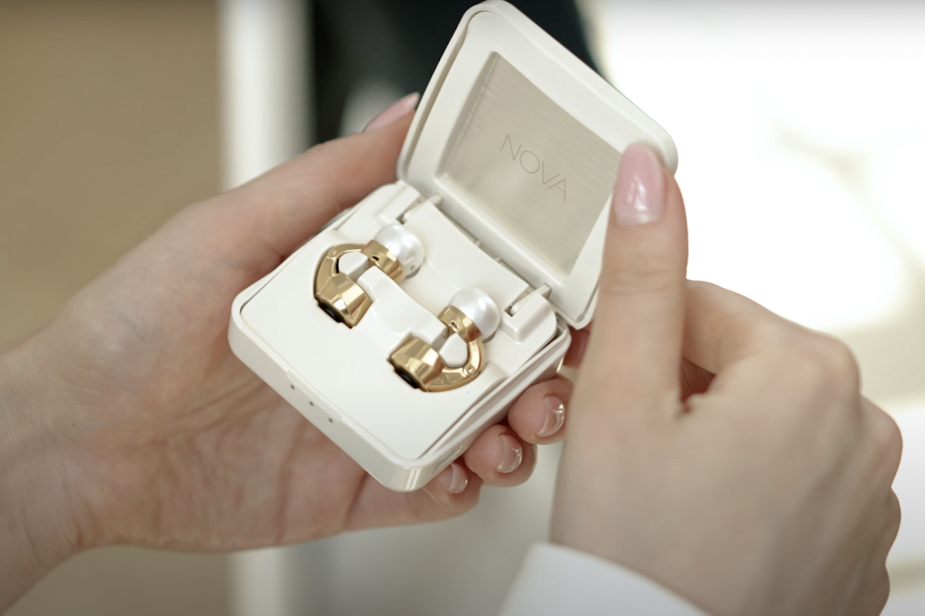 An image showing Nova’s audio earrings in their charging case