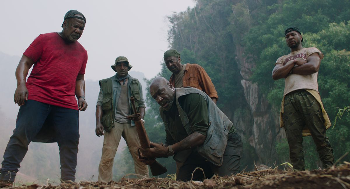 a group of men look at an excavation site
