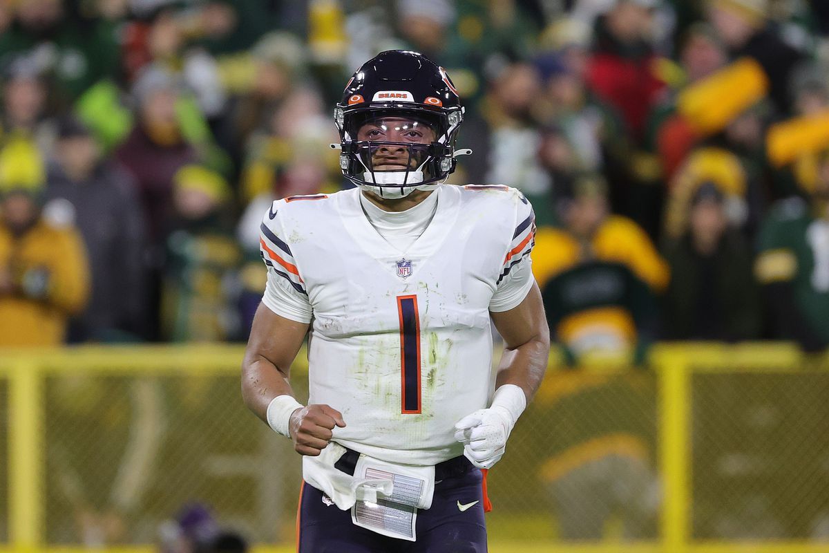 Justin Fields #1 of the Chicago Bears runs to the sideline during a game against the Green Bay Packers at Lambeau Field