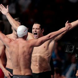 Yannick Agnel, Florent Manaudou and Fabien Gilot of France celebrate after the Swimming Men's 4x100m Freestyle.