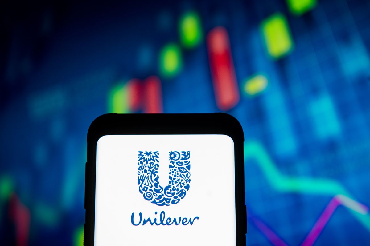 In this photo illustration the Unilever logo seen displayed...