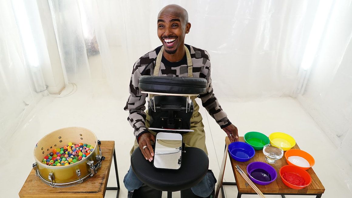 Mo Farah has a wide grin on his face as he completes a Taskmaster task.