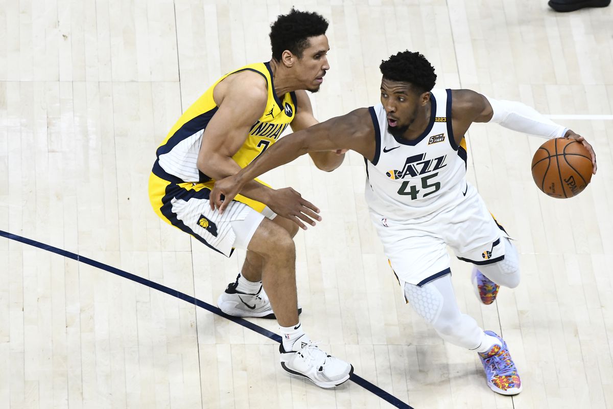 Donovan Mitchell #45 of the Utah Jazz drives past Malcolm Brogdon #7 of the Indiana Pacers during a game at Vivint Smart Home Arena on April 16, 2021 in Salt Lake City, Utah.&nbsp;