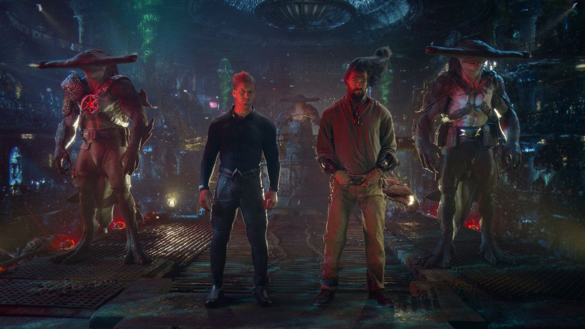 Orm and Aquaman stand guarded by hammerhead shark people in The Lost Kingdom
